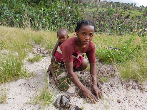 mother planting with her baby