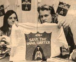 Activist holds up a "Save the Snail Darter" t-shirt